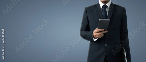 Fototapeta Man holding smartphone device touching screen
