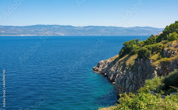 Fototapeta The late summer coastline near the hill village of Vrbnsk on Krk Island in Primorje-Gorski Kotar County in western Croatia. The Croatian mainland can be seen in the background
