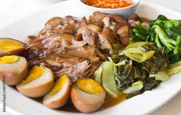 Fototapeta Stewed pork leg with five spices, served with eggs and pickle