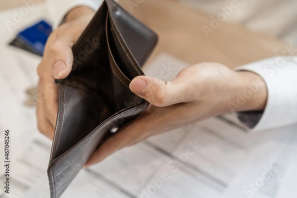 Fototapeta Stressed, Problem business person man, male holding and open an empty wallet not have money, credit card, not to payment bill, loan or expense in pay. Bankruptcy, bankrupt and debt financial concept.