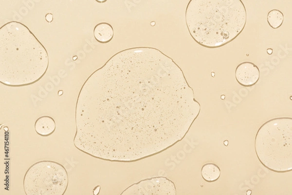 Obraz Different drops of transparent liquid soap with bubbles on pastel surface upper view. Skincare and dermatological procedures