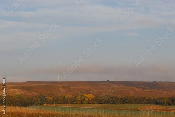 Obraz Electrical Wind Mills hiding behind low clouds