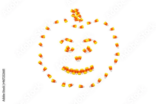 Fototapeta Candy corn arranged in the shape of a carved halloween pumpkin isolated on a white background