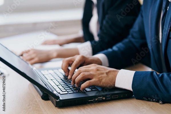 Obraz managers in the office in front of a laptop career network technologies