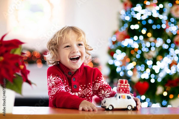Obraz Child with Christmas present. Kid with Xmas gift.