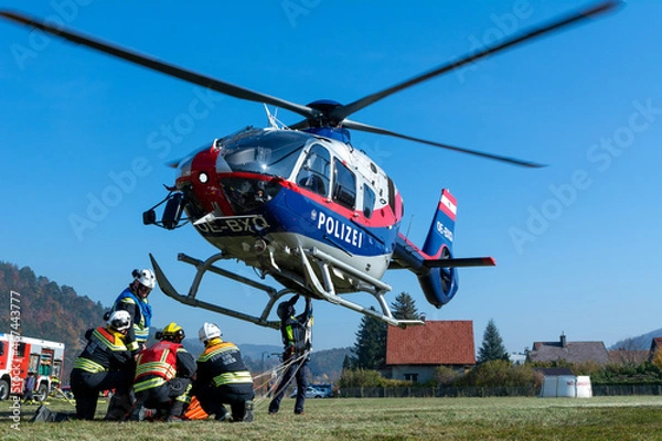 Fototapeta Firefighters supporting a Police Helicopter to transport equipment to a mountain forest fire in Hirschwang, Lower Austria