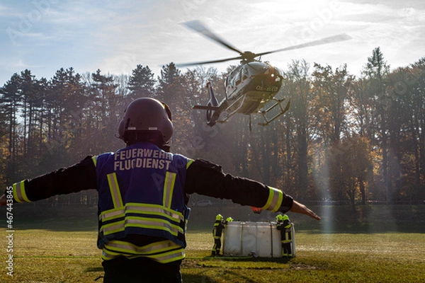 Fototapeta A Fire Department Marshaller is Marshalling signal for Helicopter during a forest fire in Hirschwang, Lower Austria