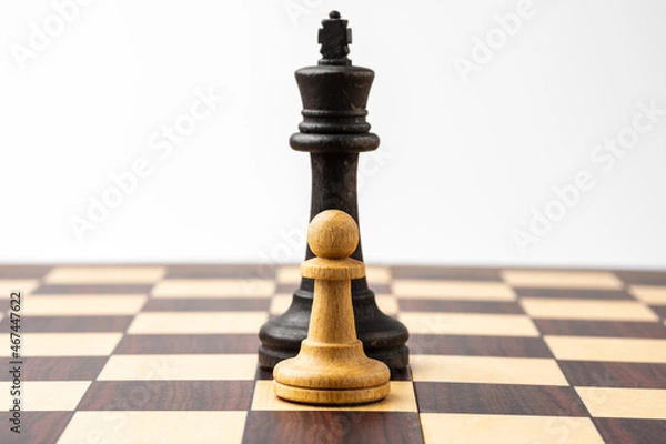 Fototapeta King and pawn on a chessboard