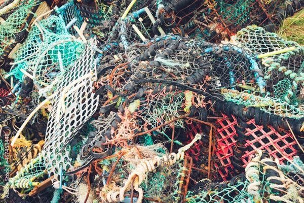 Fototapeta Messy pile of brighly coloured discarded lobster traps and ghost nets - marine debris