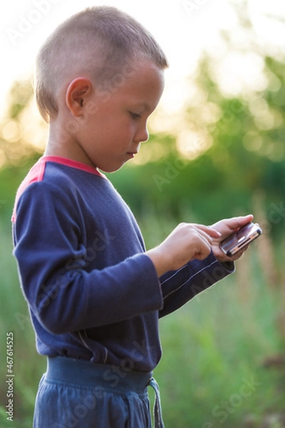 Fototapeta Child using a mobile phone