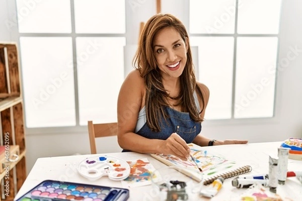Obraz Young hispanic artist woman smiling happy drawing at art studio.