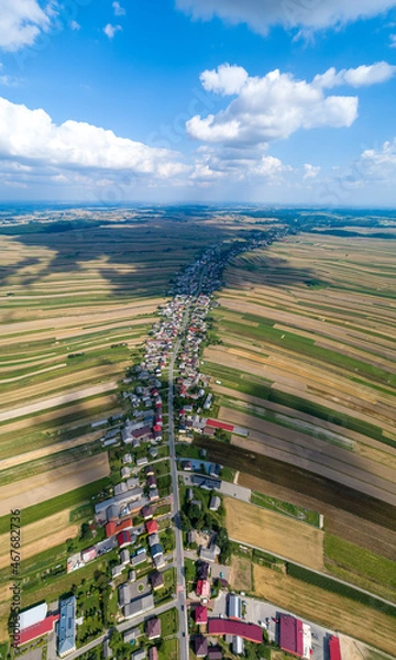 Fototapeta Village, amazing in Poland from a bird's eye view from a drone. Sułoszowa - the longest village from the drone.