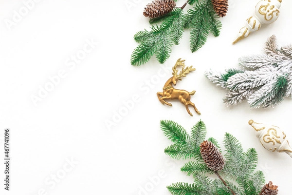 Fototapeta Gold Christmas decoration, pine cone branches on white background, flat lay, top view