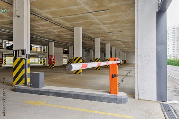 Obraz Automatic barrier gate at the entrance to a typical multi-storey car park. Closed barrier of car parking