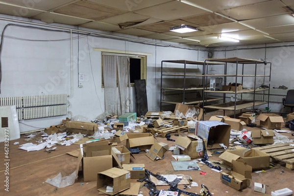 Fototapeta abandoned warehouse with scattered boxes