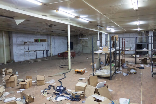 Fototapeta abandoned warehouse with scattered boxes