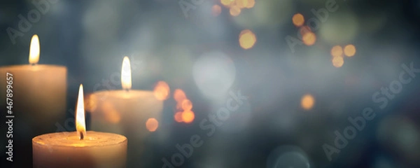 Obraz closeup of 3 burning candles on abstract black background, contemplate celebration mood with blurry lights, festive concept with copy space