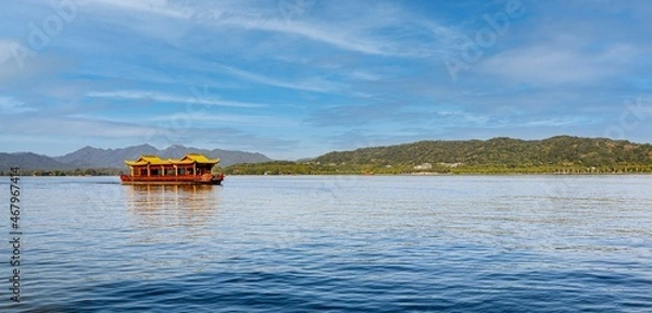 Obraz Tranquility and beautiful scenery at West Lake in Hangzhou, China, as Chinese style tour boat floats across the water