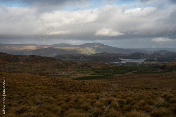 Fototapeta Taken from famous Suidhe viewpoint looking over moorland, lakes and mountains with blue sky and clouds. Scottish Highlands, near Fort Augustus.