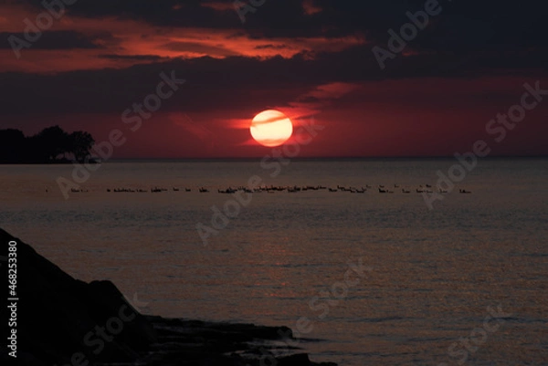 Obraz Dramatic sunset over water