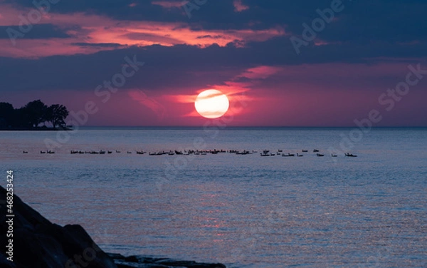 Obraz Dramatic sunset over water