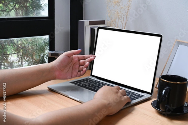 Obraz Young female working online with computer laptop at home.