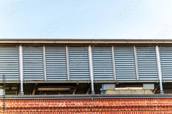 Fototapeta Central air handling unit housing located on the roof of the old, traditional, industrial brick building of engine room building in former coal mine "Michal" in Siemianowice, Silesia, Poland