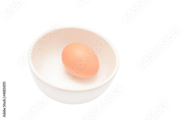 Fototapeta Eggs in a cup isolated on white background
