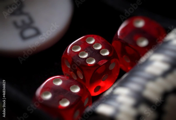 Fototapeta red playing dice, poker plastic chips, close-up, macrophotography, selective focus, blurry background, risk concept, stock exchange game, casino, gambling, gambling, excitement