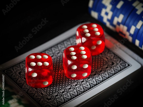 Fototapeta red playing dice, poker plastic chips, close-up, macrophotography, selective focus, blurry background, risk concept, stock exchange game, casino, gambling, gambling, excitement