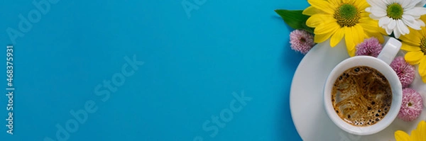 Fototapeta white coffee cup with espresso, flowers on a blue background with free space for text
