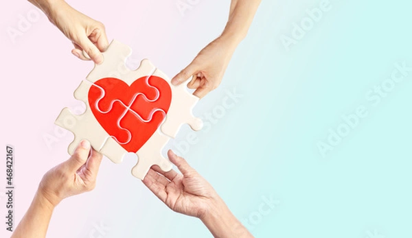 Fototapeta Hands holding white jigsaw with red heart shape inside on light pastel background, Together with Love, complete of love relationship, and Love can make different concept