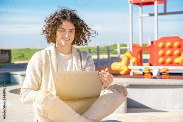 Fototapeta guy working remotely outdoor