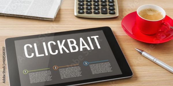 Fototapeta A tablet on a desk with the headline Clickbait