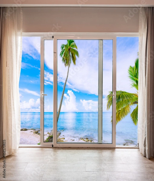 Fototapeta large glass door overlooking the beach