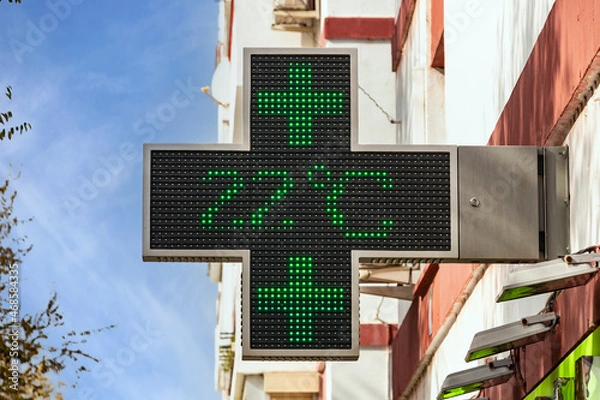 Fototapeta Electronic green pharmacy cross with the temperature indication in celsius degrees