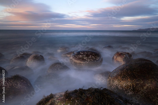 Fototapeta Sunset on the ocean with mystical fog in the foreground
