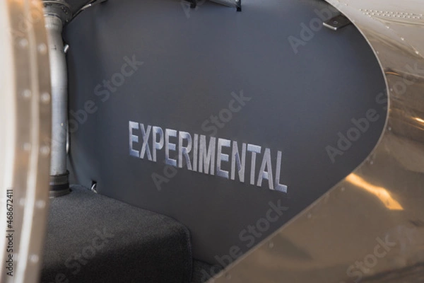 Fototapeta Experimental label on small aircraft inside 747-8F