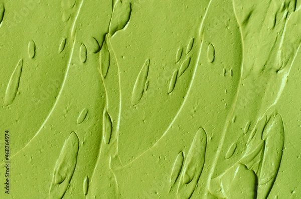 Obraz Green cosmetic clay (cucumber facial mask, avocado face cream, green tea matcha body wrap) texture close up, selective focus. Abstract background with brush strokes.