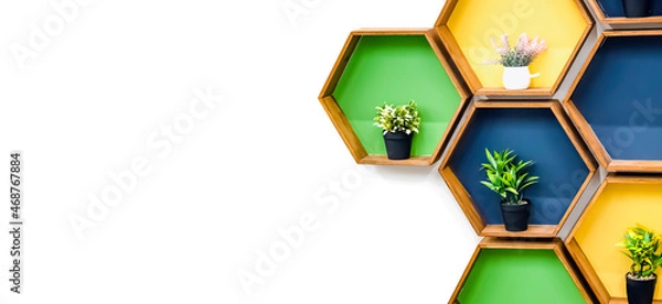 Fototapeta A banner with a white background for a furniture company with unusual colored shelves and pots with artificial flowers. Copy space. Indoors. Square shelves. Succulents as decoration.