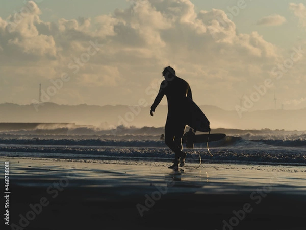 Obraz surfer on the beach at sunset