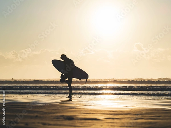 Obraz surfer on the beach at sunset