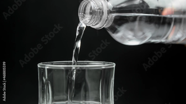 Fototapeta Bottle water poured into a glass