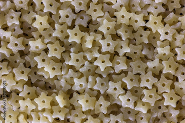 Fototapeta Close-up of durum wheat star shaped pasta with hole, baby food and first course concept. Stelline prepares quickly.