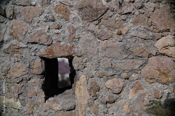 Obraz Loopholes in the stone wall of the tower of the ancient fortress