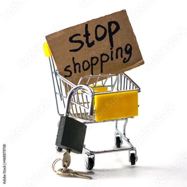 Obraz the concept of refusing to buy a reasonable consumption shopping cart with a padlock and a sign saying stop shopping on a white background