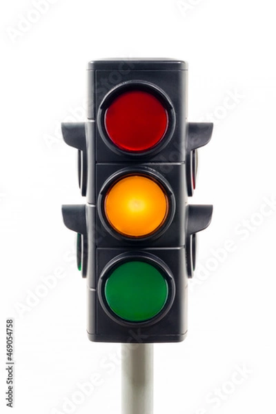 Obraz Close-up view of a traffic light showing an illuminated amber light.  Concept image illustrating change and control of the COVID 19 pandemic.

