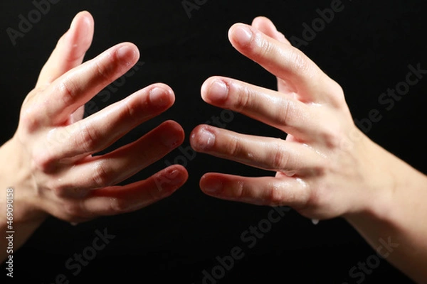 Obraz two wet palms on a black background