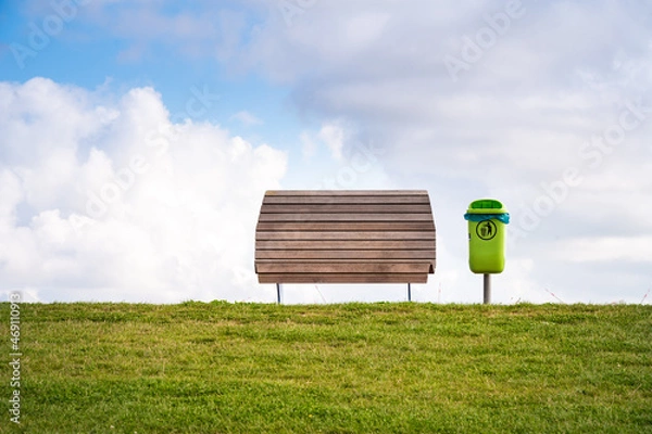 Fototapeta Bench and trash can with a sea view on the dike of Dagebüll in Schleswigholstein