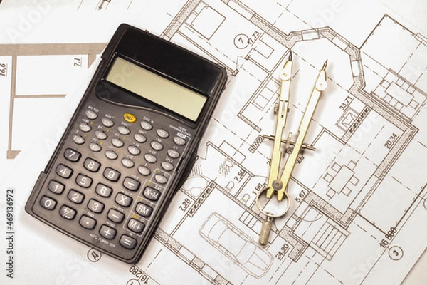 Obraz Calculation of the cost of a private country house under construction in the future. The calculator and compasses is on the house plan. 